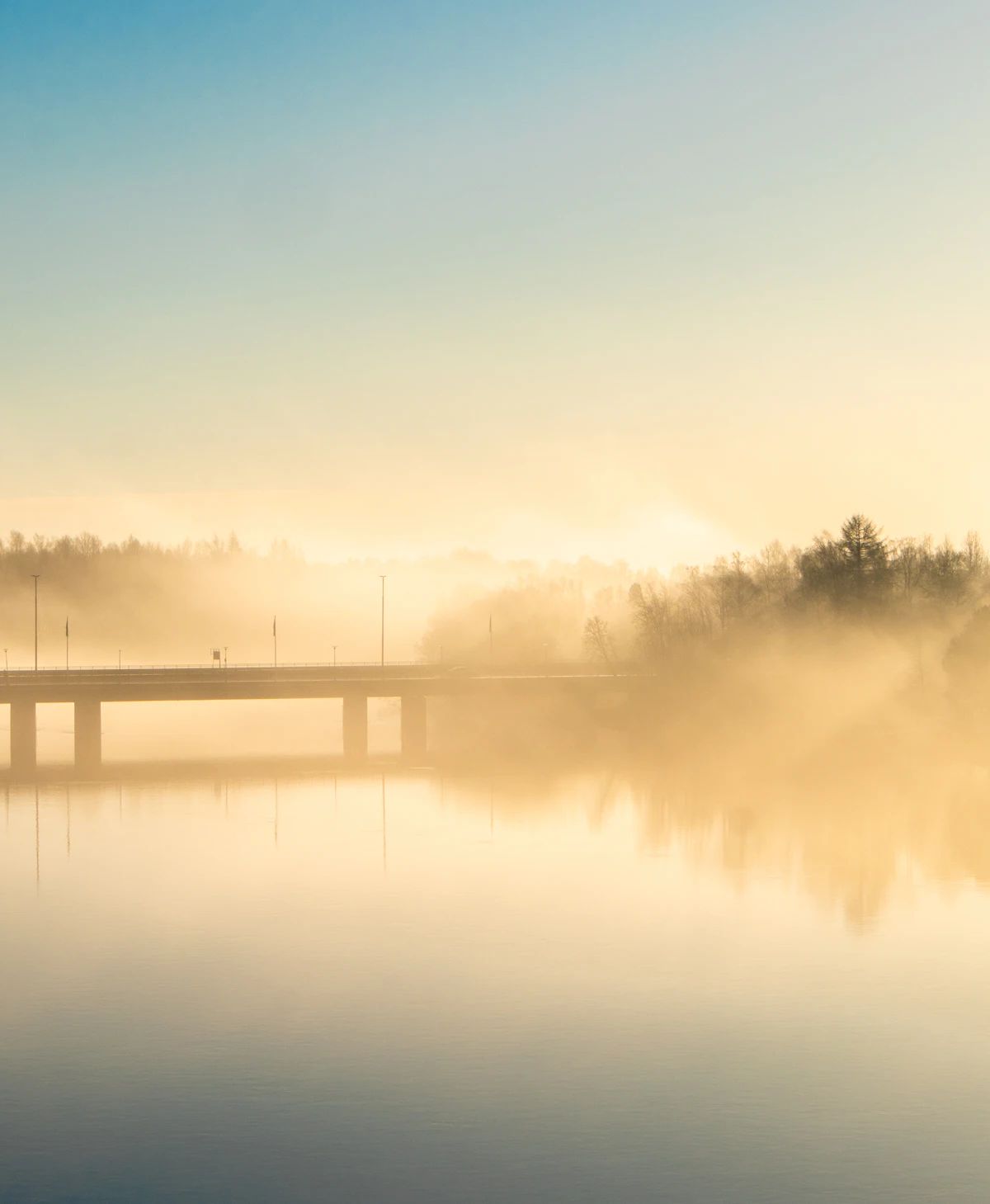 A bridge over the water on a foggy morning in Umeå.