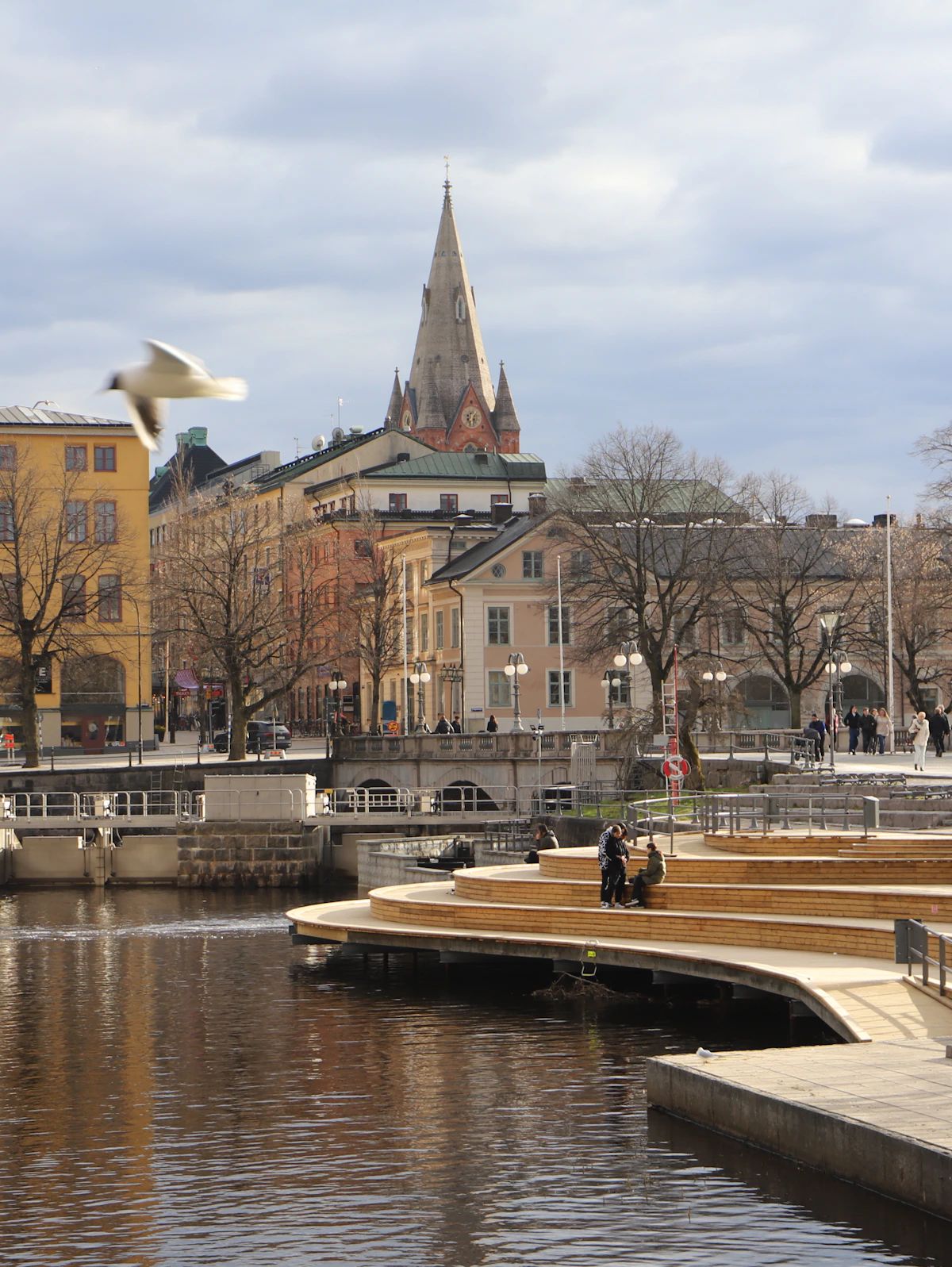 Buildings along the Svartån river in Örebro reflected in the water.